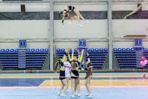 Cheerleader being thrown in the air