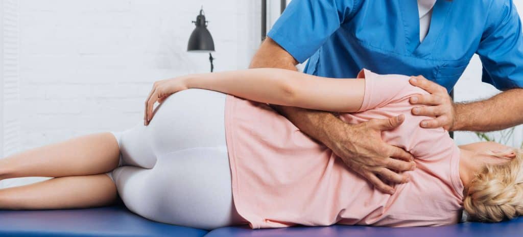 Woman receiving chiropractic back adjustment